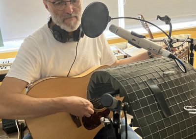 man recording guitar