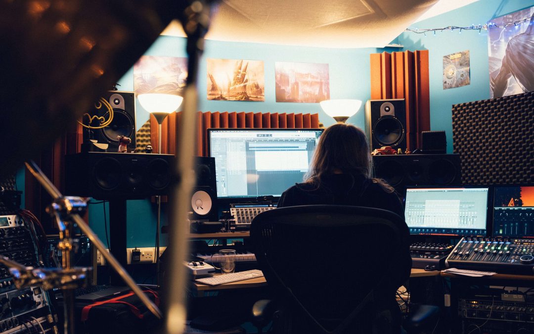 person sitting at desk in recording studio