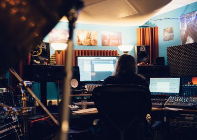 person sitting at desk in recording studio